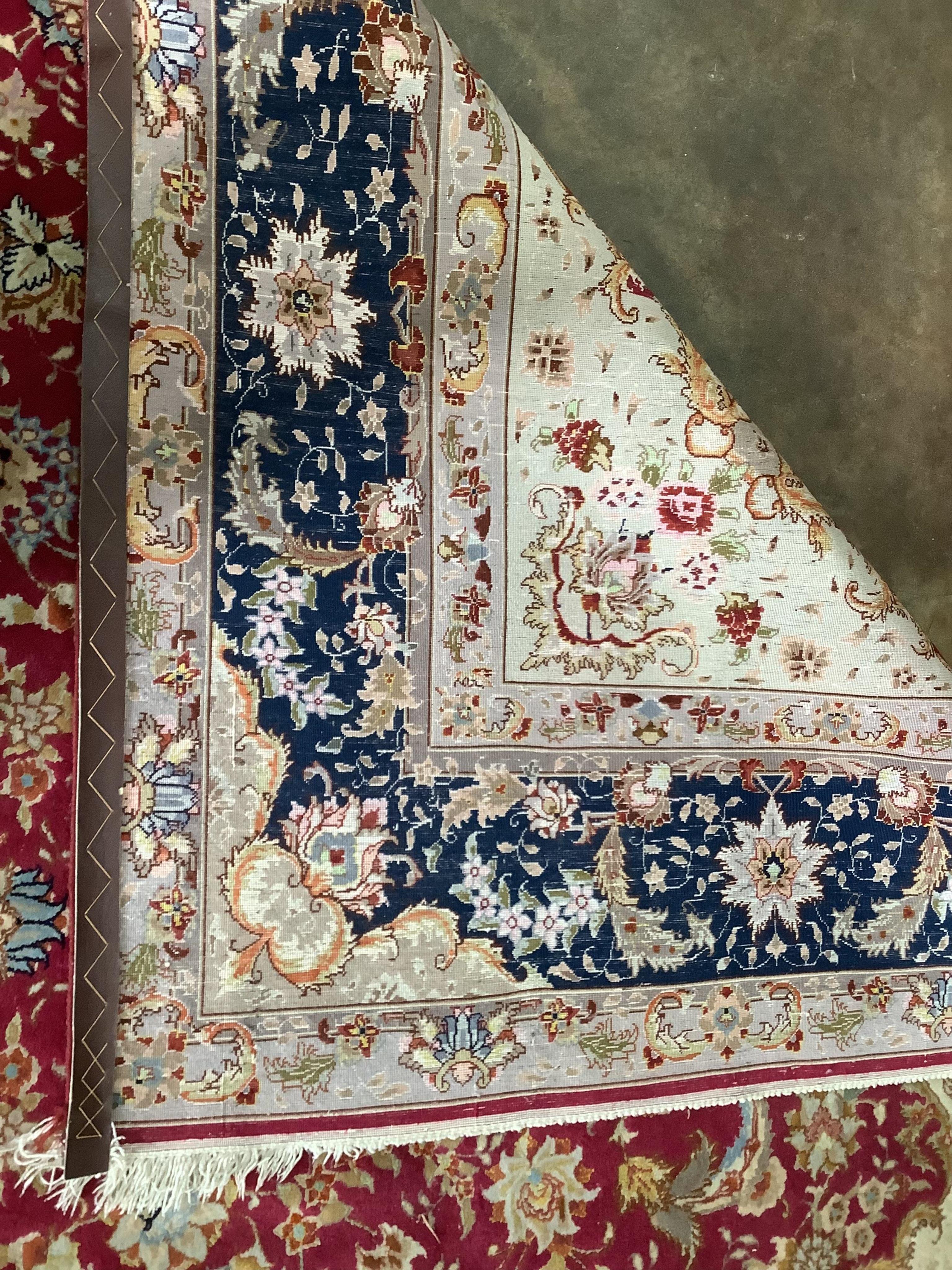 A Tabriz burgundy ground carpet, 300 x 200cm. Condition - fair